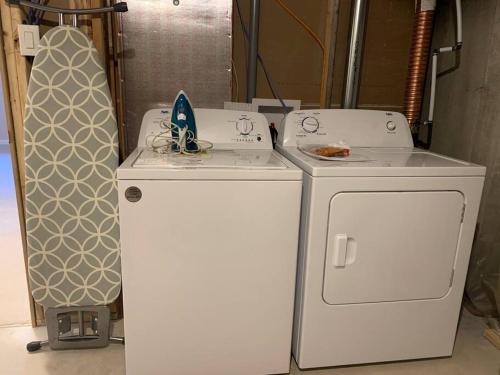 two washing machines and a refrigerator in a room at Brand new house in Ottawa