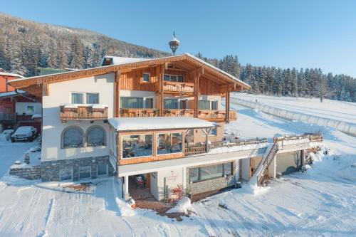a large house in the snow with snow at Landhotel Anna in Sankt Martin am Tennengebirge