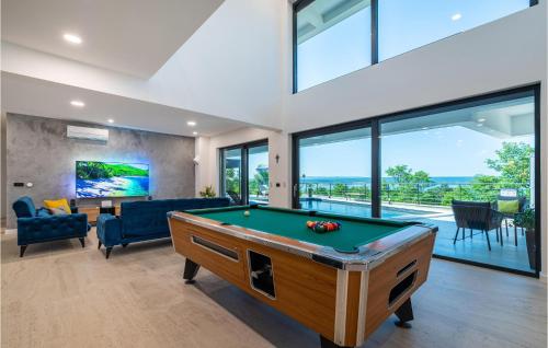 a living room with a pool table in a house at Villa Hill in Maslenica