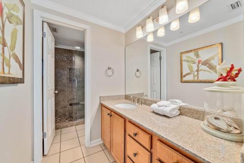 a bathroom with a sink and a mirror at Phoenix 10 Unit 1514 in Orange Beach