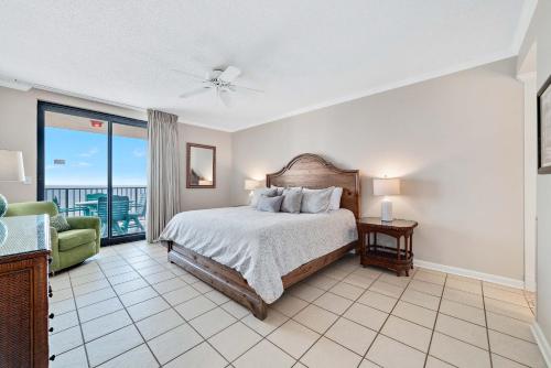 a bedroom with a bed and a balcony at Phoenix 10 Unit 1514 in Orange Beach