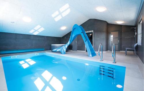 a large swimming pool with a slide in a house at Awesome Home In Jerup With Kitchen in Bratten Strand
