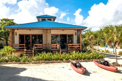 two kayaks on the sand in front of a building at Special Offer Oceanfront Private Estate By Alom in San Pedro