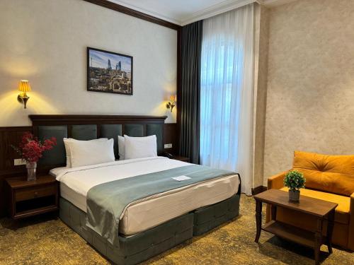 a hotel room with a bed and a window at Midway Hotel Baku in Baku