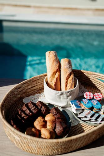 a tray of bread and pastries on a table at Magnolia Villas Potos Thassos in Potos