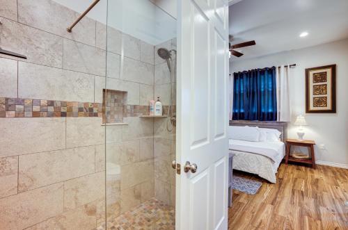 a bathroom with a shower and a bedroom with a bed at Pet-Friendly Tomball Home Walk to Main Street! in Tomball