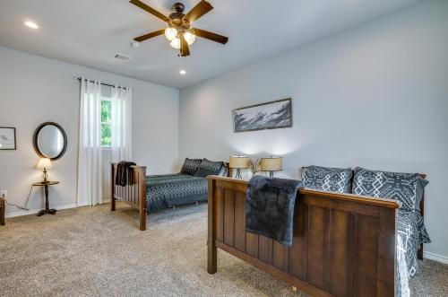 a living room with a couch and a ceiling fan at Pet-Friendly Tomball Home Walk to Main Street! in Tomball