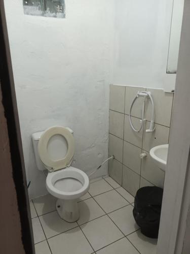 a bathroom with a toilet and a sink at Hostel Espaço Mulher in Florianópolis