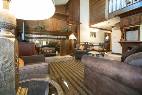a living room with a couch and a fireplace at Sunburst Condominiums in Steamboat Springs