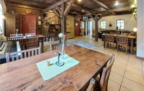 a dining room with a wooden table and a kitchen at 7 Bedroom Gorgeous Home In Ubbalt in Ubbalt