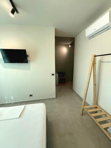 a living room with a tv on the wall at STAY-FIVE rooms & apartments in Shkodër