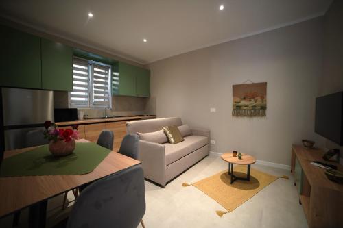 a living room with a couch and a table at Center Oasis Appartmens in Tirana
