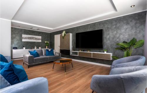 a living room with couches and a flat screen tv at Beautiful Home In Opric With Wifi in Opric