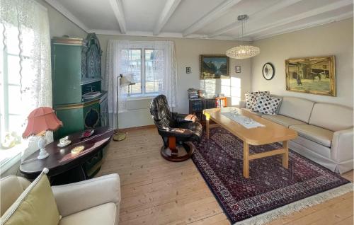 a living room with a couch and a table at 4 Bedroom Cozy Home In Svorkmo in Brattli