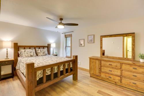 a bedroom with a bed and a dresser and a mirror at 5 Mi to Whitefish Resort Minutes to Chairlifts! in Whitefish