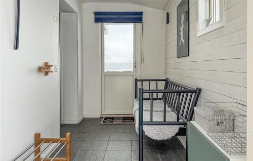 a hallway with a staircase with a cross on the wall at 2 Bedroom Nice Home In Nässjö in Nässjö