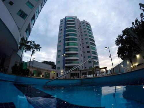 a building with a swimming pool in front of a building at Apartamento em Caldas Novas, GO, Cond Fiore Prime in Caldas Novas
