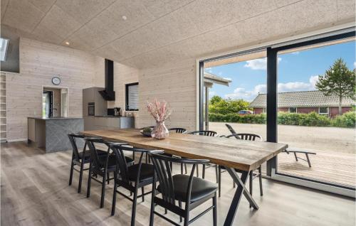 a kitchen and dining room with a wooden table and chairs at Nice Home In Tarm With Wifi in Tarm