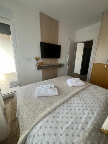 a bedroom with a bed with two towels on it at Marshall Apartments - Zlatibor in Zlatibor