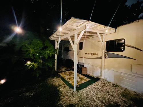 awning over an rv at night at RV in the Little Jungle by Legnalife in Homestead