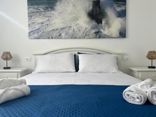 a bedroom with a bed with towels on it at SEA&SUN House in Marinella di Sarzana