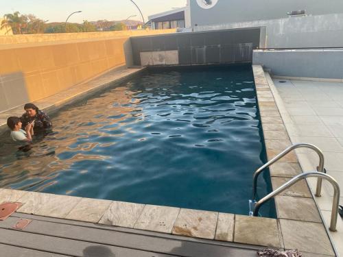 a pool of water with two people in it at Tranquility Luxury Suite, 77 on Independence Ave in Windhoek