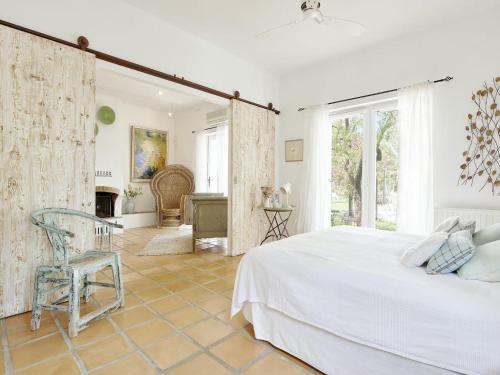 マドリードにあるVilla in Sant Josep near Beautiful Beachesのベッドと椅子のある白い寝室