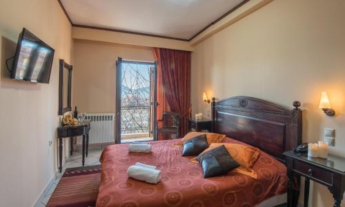 a bedroom with a large bed with two pillows on it at Marianna's Home Accommodation in Karpenision