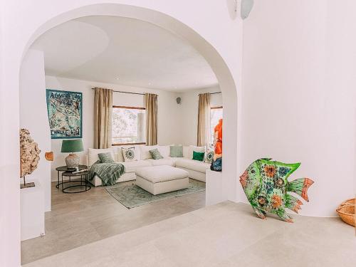 a living room with a white couch and an archway at Holiday Home in Ibiza near Las Salinas Beach in Cala Vadella