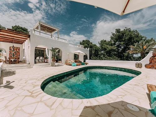 a house with a swimming pool in a yard at Holiday Home in Ibiza near Las Salinas Beach in Cala Vadella