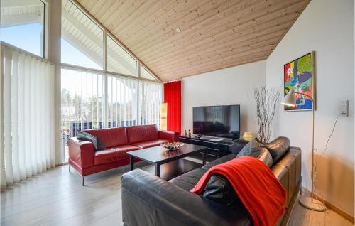 a living room with a couch and a tv at Four-Bedroom Holiday Home Glesborg With A Room Hot Tub 07 in Fjellerup