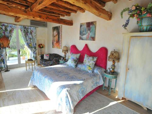 a bedroom with a large bed with a red headboard at Apartment in Ibiza near Cala Conta Beach in Sant Carles de Peralta