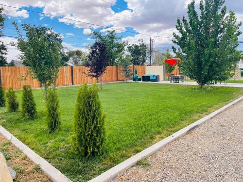 a yard with trees and a fence at Blue Sage Inn & Suites in Blanding