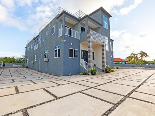 a house with a large parking lot at Paradise Point Company Limited in Treasure Beach