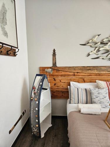 a bedroom with a bed with a wooden headboard at VILLA VILLACOLLE in Procchio