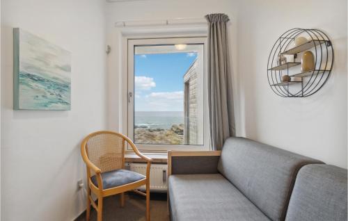 a living room with a couch and a window at Cozy Apartment In Allinge With Kitchen in Sandvig