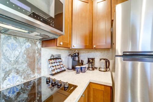 a kitchen with wooden cabinets and a stainless steel refrigerator at Walk to Trails Sedona Casita on Thunder Mountain in Sedona