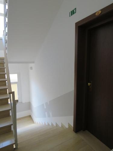 a black door in a room with a staircase at Hotel Marta in Forlì