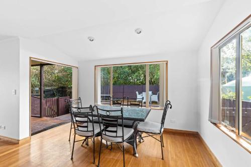 a dining room with a table and chairs at Aroha at Tata - Golden Bay Holiday Home in Takaka