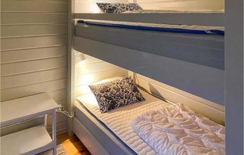 a couple of bunk beds in a room at Nice Home In Hjältevad With Sauna in Hjältevad