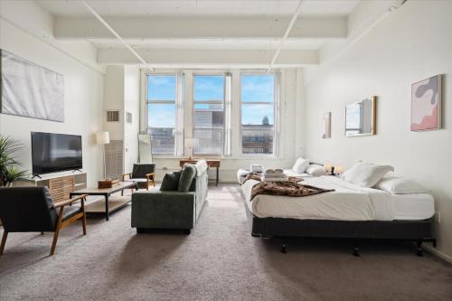 a bedroom with a large bed and a living room at Loft640 Studio, Free Parking, Kitchen, Workspace, Great Location in Philadelphia