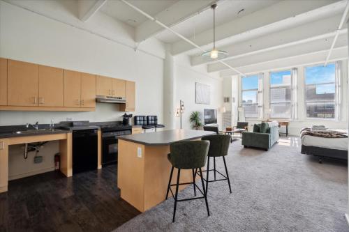 an open kitchen and living room with a table and chairs at Loft640 Studio, Free Parking, Kitchen, Workspace, Great Location in Philadelphia
