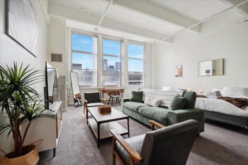 a living room with a bed and a couch at Loft640 Studio, Free Parking, Kitchen, Workspace, Great Location in Philadelphia