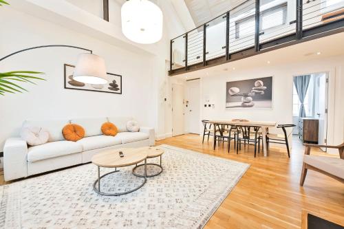 a living room with a couch and a table at Light and Airy Central London Apartment in London