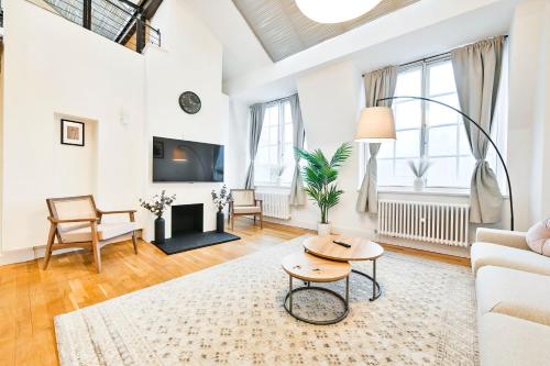 a living room with a couch and a table at Light and Airy Central London Apartment in London