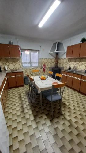 a kitchen with a table and chairs in a room at Casa do Tonito in Carregal do Sal