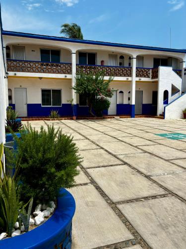 a large building with blue and white at Costa Dorada in Barra de Navidad