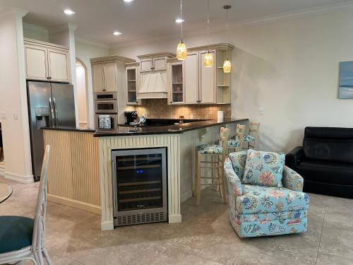 a kitchen with a fireplace and a couch and a chair at the Cape House in Cape Canaveral