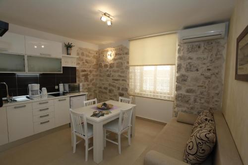a kitchen and living room with a couch and a table at Apartment Vallamar free parking in Zadar