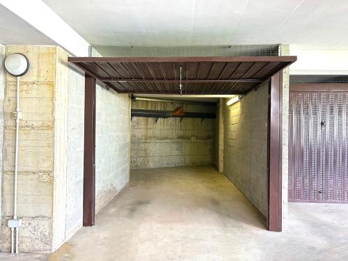 an empty hallway in a building with a ceiling at Nest Blevio apartment with private garage in Blevio